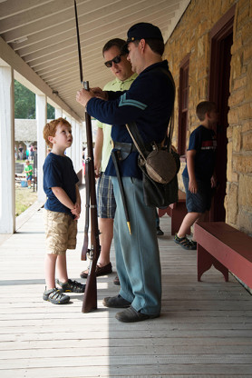 A civil war soldier (on Civil War weekend a few years ago) talks to an obviously mesmerized young boy.