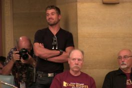 Kris Kranz with a pistol jutting on his hip at the Minnesota Capitol
