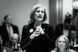 Kristen Robbins holds microphone in Minnesota House chamber