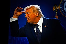 Donald Trump peering out from hand-shaded eyes